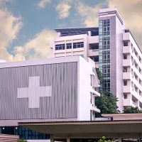 hospital building with big symbolic at cloudy day
